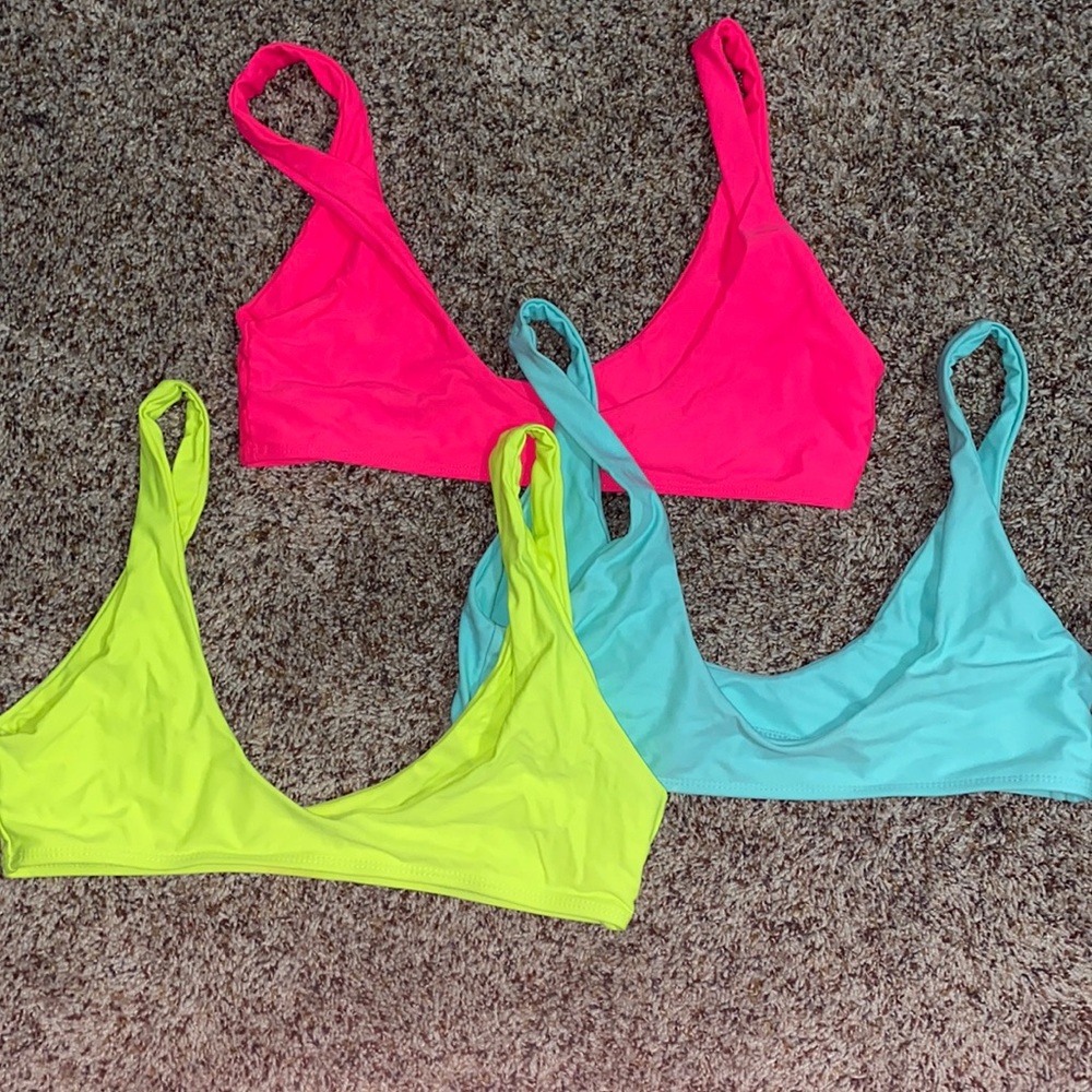 3 neon bathing suit tops. Very bright and colorful.